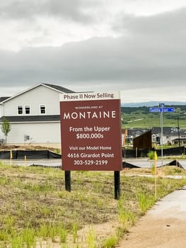 Castle Rock, Colorado, USA-June 11, 2023-Wide angle panoramic view of the Montaine community in Castle Rock Colorado showcasing a beautifully designed landscape with walking paths native plants stone benches and a clubhouse in the background The open green spaces and modern amenities highlight the communitys outdoor living appeal