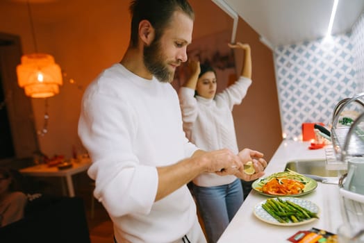 A lovely couple shares delightful moments as they enjoy cooking together in their warm and inviting kitchen space