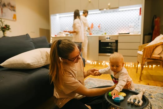 In a stylish kitchen, a parent playfully interacts with their baby, creating joyful memories together
