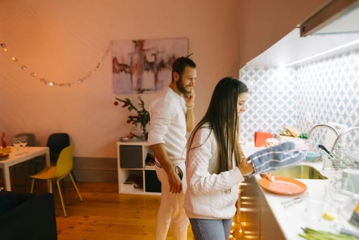 A loving couple enjoys their precious time together while preparing delicious food in a stylish modern kitchen