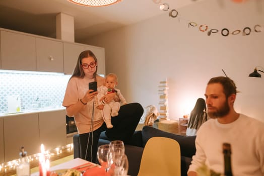 A warm family gathering filled with a delightful baby, cherished friends, and inviting, cozy decor all around