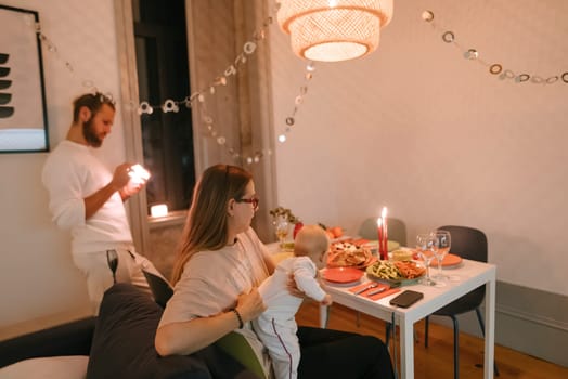 A heartwarming and inviting family dinner scene that showcases a baby surrounded by beautiful festive decor