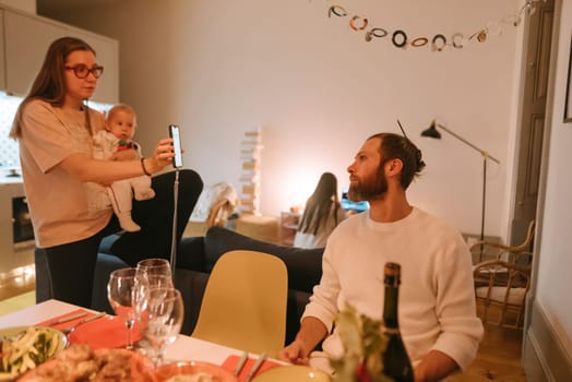A warm and cozy family scene featuring a delightful baby, relishing a festive dinner in a modern and inviting setting