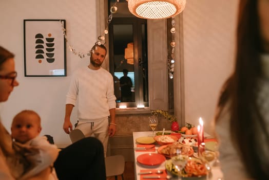 A charming and intimate dinner party where friends are enjoying a wonderful festive meal together, creating memories