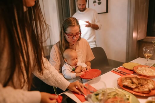 A warm and cozy family gathering that features a joyful baby, delicious food, and delightful moments shared