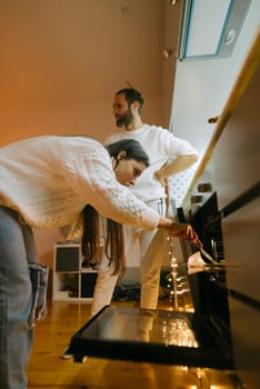 A couple joyfully cooks together in their modern kitchen, showcasing teamwork and genuine affection