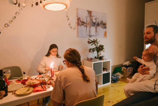 A heartwarming family gathering that features a delightful dinner, soft candlelight, and an adorable baby