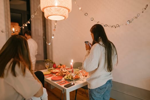 A warm and cozy dinner setting showcasing good friends joyfully enjoying a festive celebration together