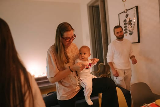 Capturing a heartfelt and warm family moment with a baby during a cozy and delightful gathering event