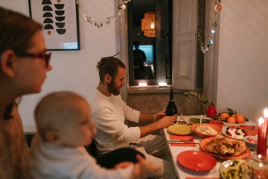 A heartwarming family gathering with a beautifully set dinner table, candlelight, and joyful moments shared