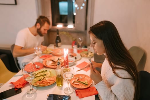 A cozy dinner scene of a loving couple savoring a delicious meal, surrounded by flickering candles and beautiful dishes