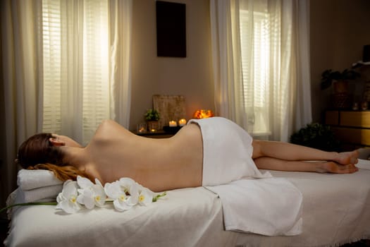 A serene and peaceful spa scene featuring a relaxing massage complemented by elegant, fragrant flowers