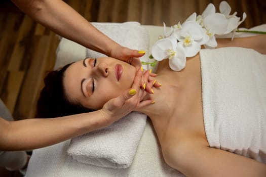 A tranquil spa scene with a luxurious facial massage and elegant flowers for the ultimate relaxation