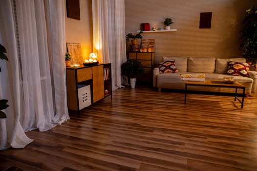 A beautifully serene living room adorned with warm lighting and sleek modern furnishings creates a tranquil atmosphere