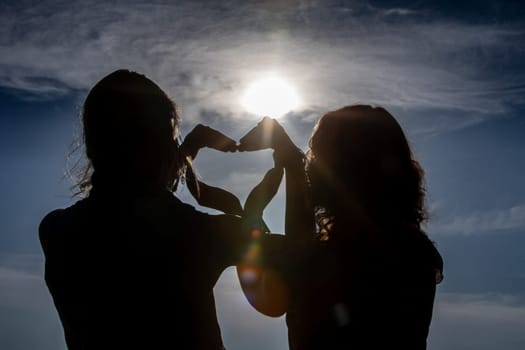 A stunning and beautiful silhouette image that powerfully conveys love and deep connection against a bright sunny sky