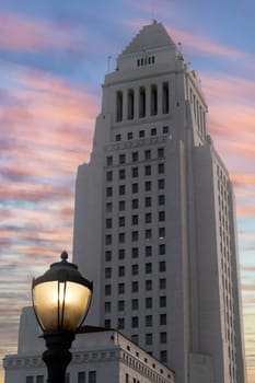 Los Angeles City Hall at dusk with vintage antique post style street light with blue sky and colorful wispy clouds. High quality photo
