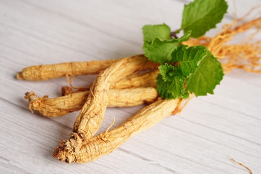 Ginseng roots and green leaf, organic nature healthy food.