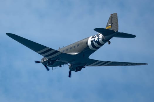 WWII D day june 6th aircraft Douglas DC-47 troop Carrier in flight. Sunny day light cloud wisps. High quality photo