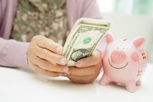 Retired elderly woman counting coins money with piggy bank and worry about monthly expenses and treatment fee payment.