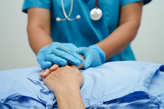 Doctor holding hands Asian elderly woman patient, help and care in hospital.