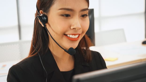 Business people wearing headset working in office to support remote customer or colleague. Call center, telemarketing, customer support agent provide service on telephone video conference call. Jivy