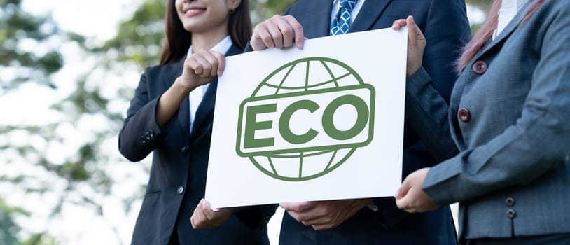 Group of business people stand united, holding eco-friendly idea and concept for environmental awareness campaign embracing eco friendly and greener environment with inspire positive change.Gyre