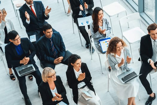 Group of business people meeting in a seminar conference . Audience listening to instructor in employee education training session . Office worker community summit forum with expert speaker . Jivy