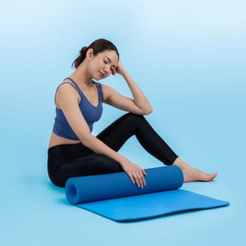 Young attractive asian woman portrait in sportswear with exercising mat. Healthy exercise and workout routine lifestyle concept. Studio shot isolated background. Vigorous