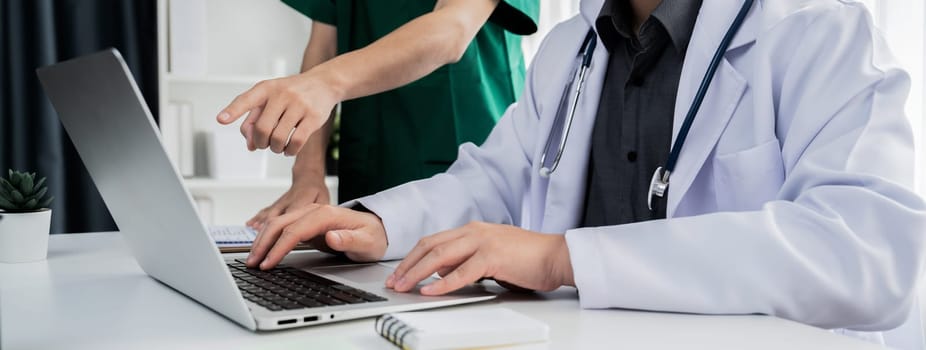 Professional various team of medical working and planning medical treatment at hospital table together. Teamwork lead to successful illness and sickness treatment. Panorama Rigid