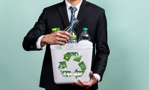 Eco friendly business with ESG commitment to make greener campaign with corporate recycling and waste management. Businessman hold recycle bin promoting sustainable clean environment. Reliance