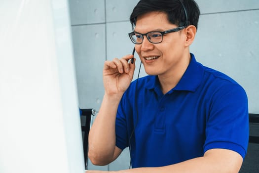 Business people wearing headset working in office to support remote customer or colleague. Call center, telemarketing, customer support agent provide service on telephone video conference call. Jivy