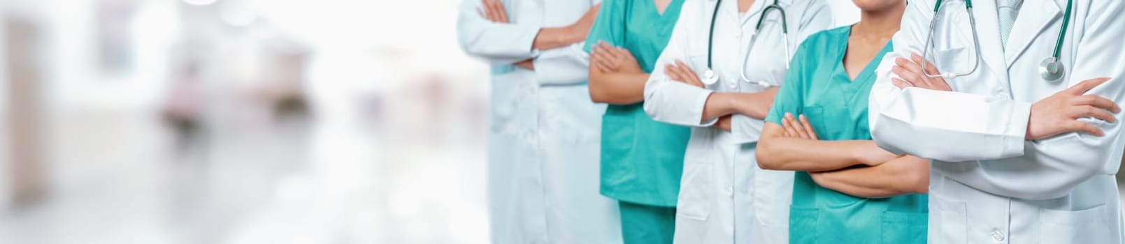 Confident medical staff team with doctor nurse and healthcare specialist professions people in blurry hospital corridor background. Medical and healthcare community in panoramic banner. Neoteric