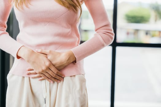 Sad Woman Stomach Ache from menstruation. young female unhappy unwell sick ill hand holding on stomach suffers pain at home, Abdomen bloating and Chronic gastritis concept