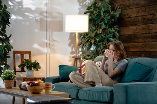 A tranquil and serene living room featuring a relaxed person who is truly enjoying a peaceful moment of leisure