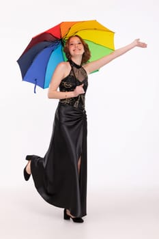 A vibrant photo shows a woman in a sleek black dress joyfully holding a colorful umbrella, radiating happiness