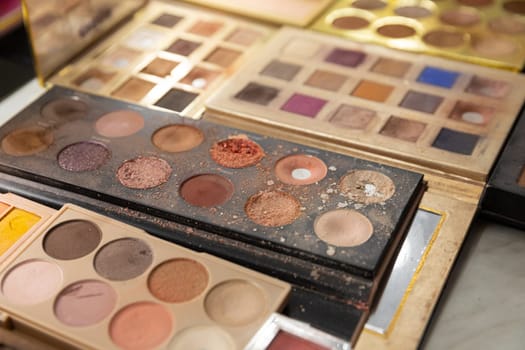 A collection of eye shadow palettes featuring diverse colors and textures for creative makeup looks.