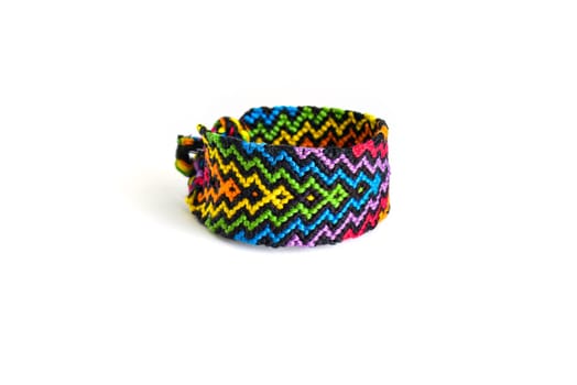 Multicolored woven DIY friendship bracelets handmade of embroidery bright thread with knots isolated on white background