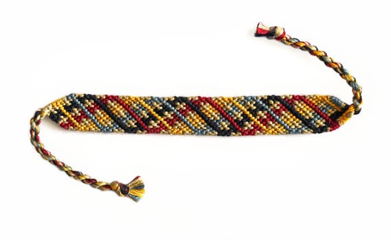 Multicolored woven DIY friendship bracelets handmade of embroidery bright thread with knots isolated on white backgroundMulticolored woven DIY friendship bracelets handmade of embroidery bright thread with knots isolated on white background