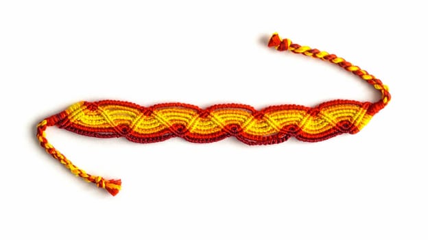 Multicolored woven DIY friendship bracelets handmade of embroidery bright thread with knots isolated on white background