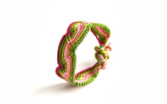 Multicolored woven DIY friendship bracelets handmade of embroidery bright thread with knots isolated on white background