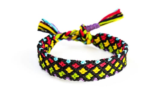 Multicolored woven DIY friendship bracelets handmade of embroidery bright thread with knots isolated on white background