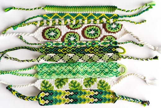 Woven DIY friendship bracelets handmade of embroidery floss with knots in green style