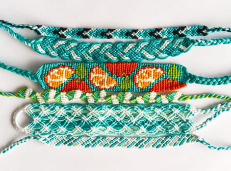 Woven DIY friendship bracelets handmade of embroidery floss with knots in blue style