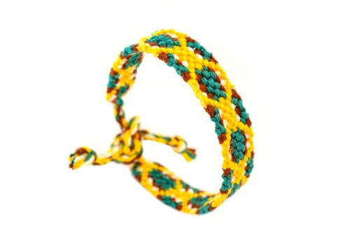 Multicolored woven DIY friendship bracelets handmade of embroidery bright thread with knots isolated on white background
