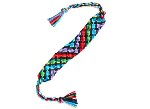 Multicolored woven DIY friendship bracelets handmade of embroidery bright thread with knots isolated on white background