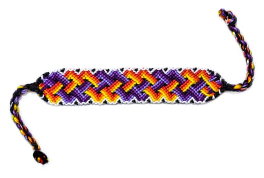 Multicolored woven DIY friendship bracelets handmade of embroidery bright thread with knots isolated on white background