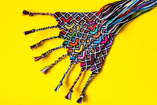 Unfinished DIY woven friendship bracelets with abstract geometric pattern. Summer accessories