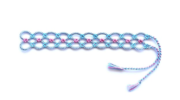Multicolored woven DIY friendship bracelets handmade of embroidery bright thread with knots isolated on white background