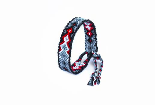 Multicolored woven DIY friendship bracelets handmade of embroidery bright thread with knots isolated on white background