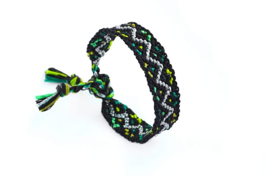 Multicolored woven DIY friendship bracelets handmade of embroidery bright thread with knots isolated on white background